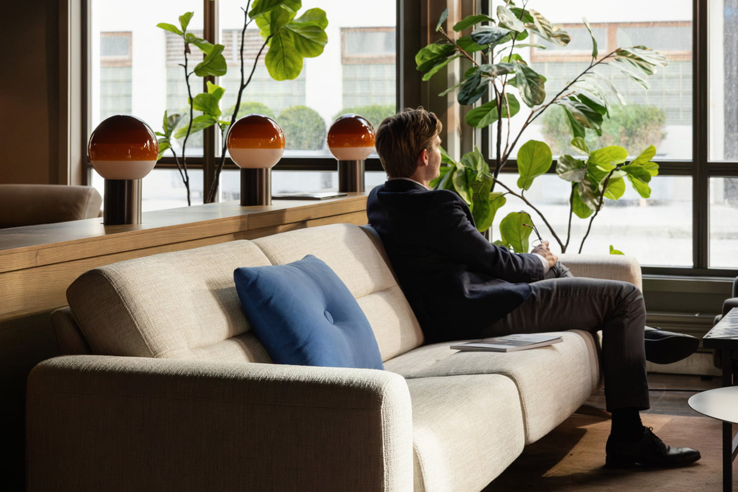 Man in a Stressless sofa in a hotel lounge area